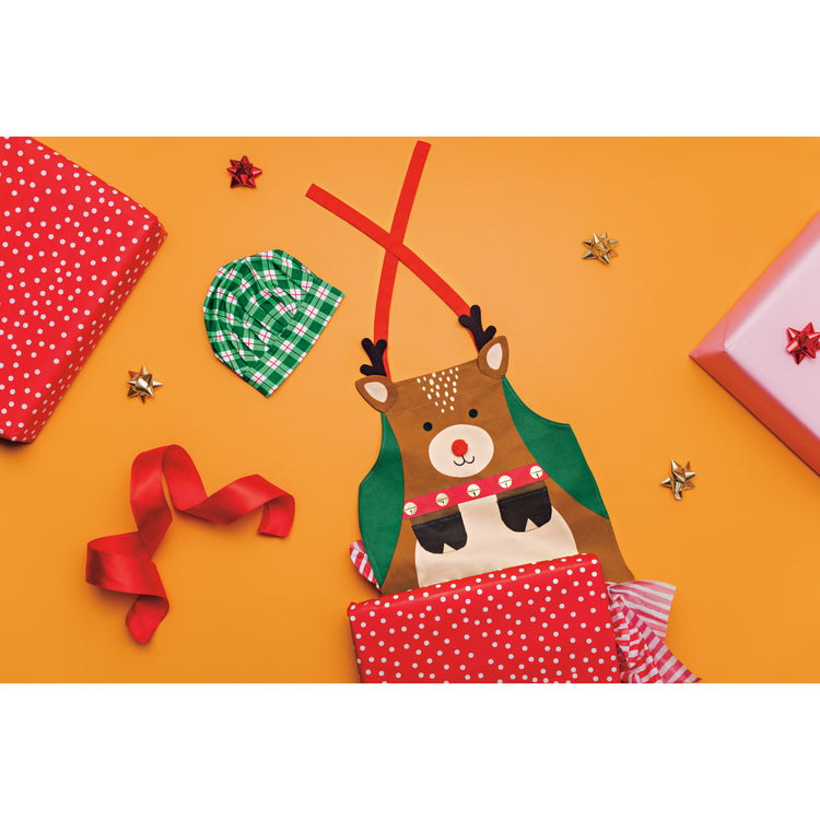 A Danica Jubilee Daydream Kid's Apron that has a Christmas reindeer on it and a coordinating green plaid chef's hat.