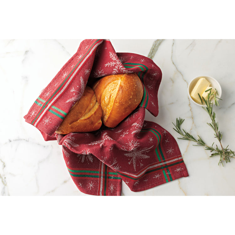 Two loaves of bread on a Now Designs Christmas Winterberry jacquard dishtowel.