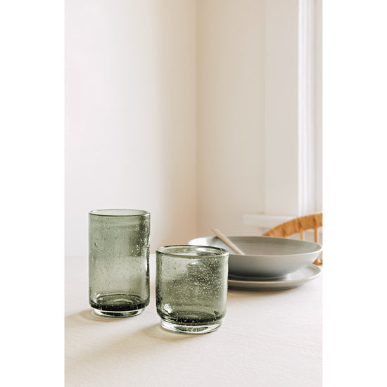 Two Heirloom Agave green Bubbled Tumbler glasses sitting on a table.