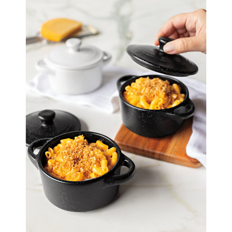Two black Now Designs cocottes with macaroni and cheese.