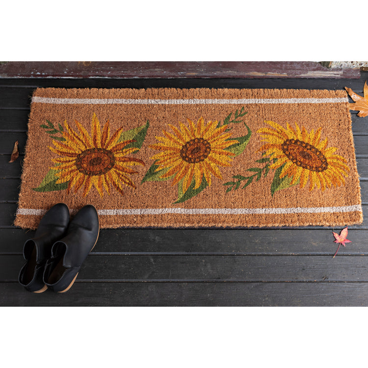 A Now Designs floral Sunflower Splendor estate doormat with sunflowers printed on it.